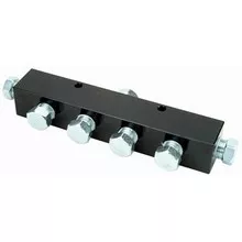 Black 4-way hydraulic manifold block with silver plugs.
