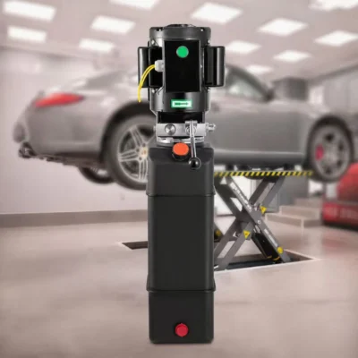 Vertical black car lift pump displayed in front of a blurred garage with a vehicle on a lift.